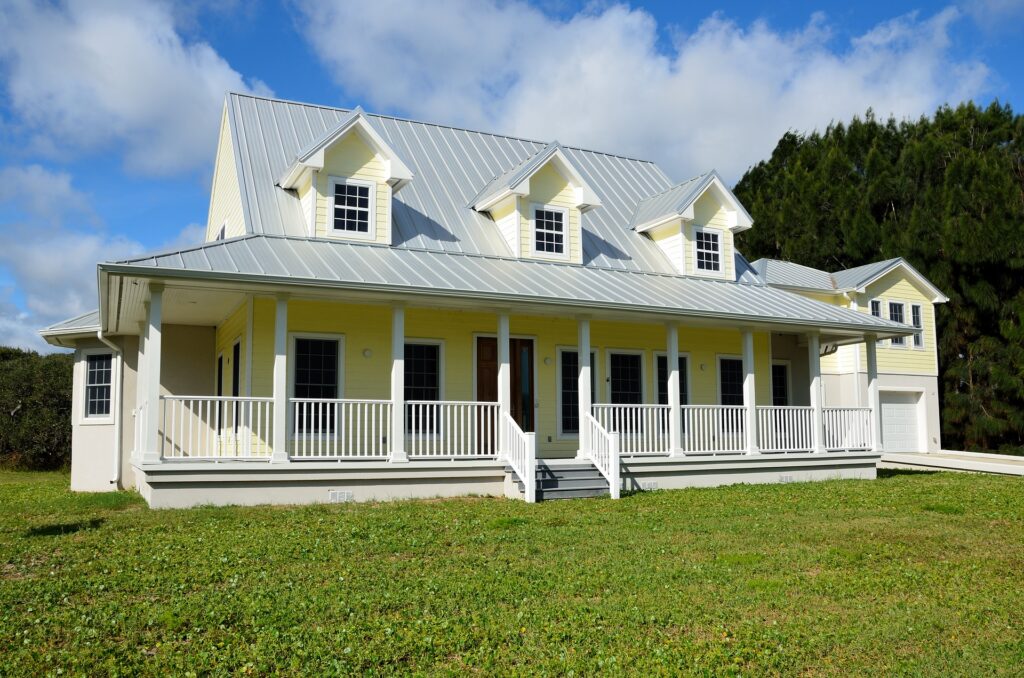 House with porch green grass blue sky